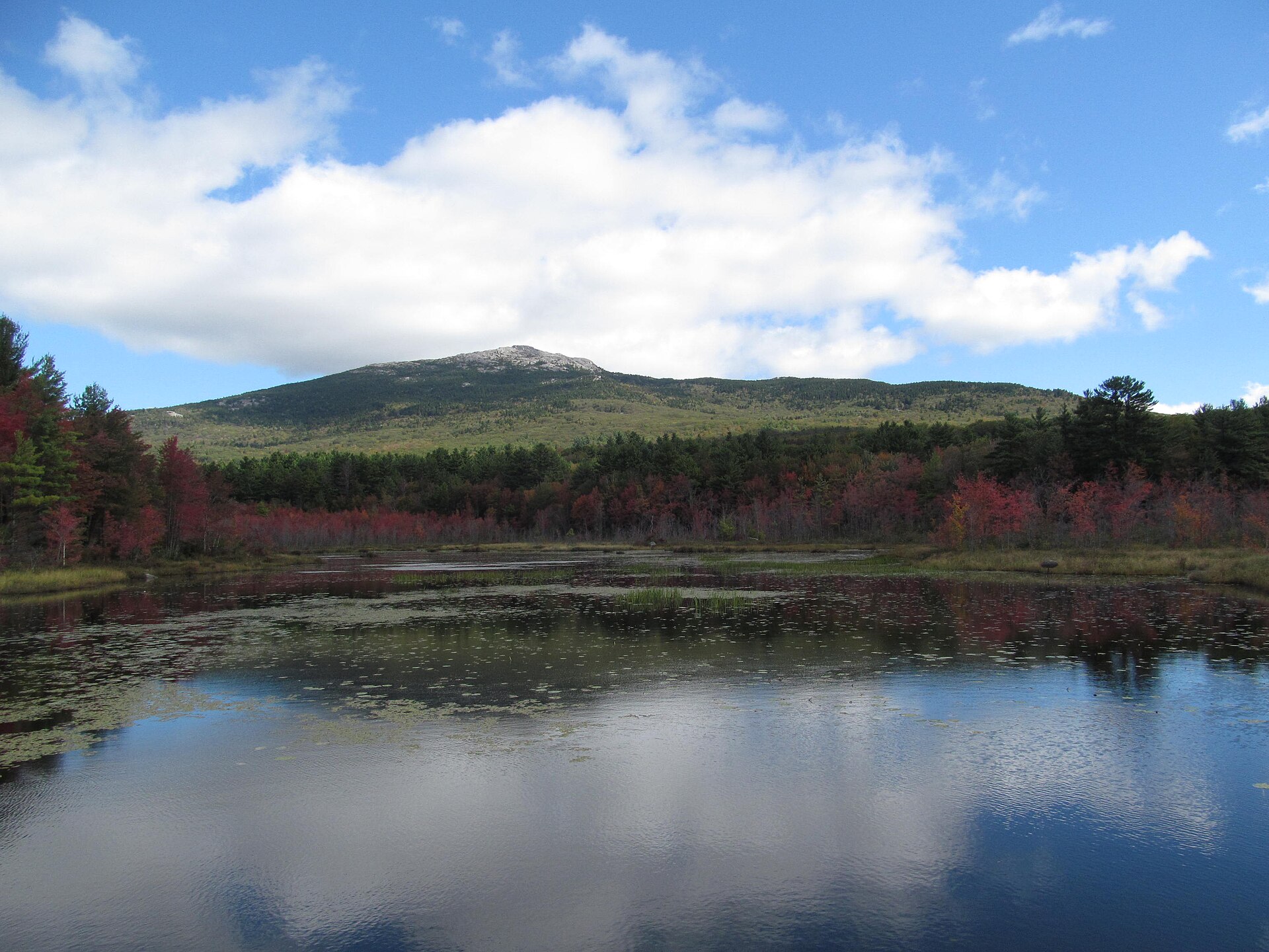 Mount Monadnock above a pond and early autumn color in Jaffrey, New Hampshire